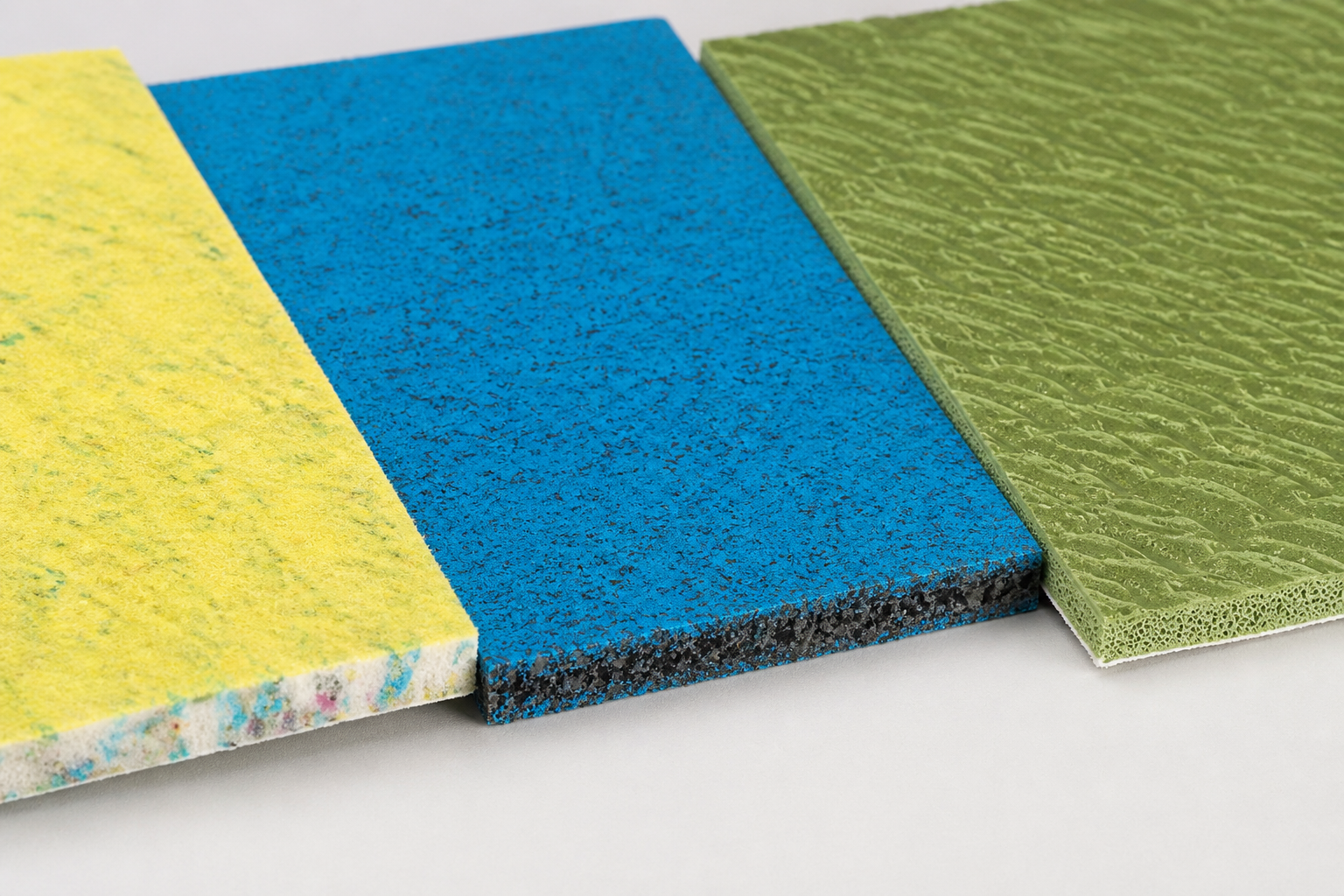 Yellow PU foam, blue crumb rubber and green moulded sponge rubber carpet underlay samples.