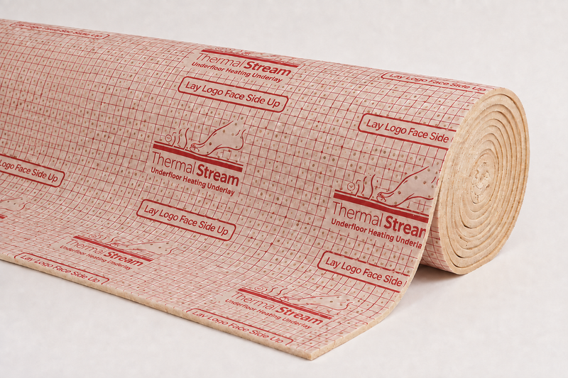 Partially unrolled ThermalStream carpet underlay with cream perforated facing and red printed grid.
